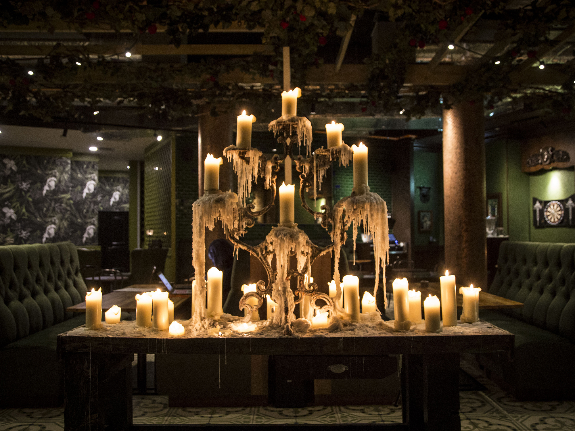 Photo of an ornate candle centre piece in a club bar
